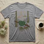 Green Tree Python Home Range T-Shirt in Sport Grey — Woodcut-style illustration of a green tree python coiled in a saddle over a branch with palms and tall trunks behind, no on-shirt text.