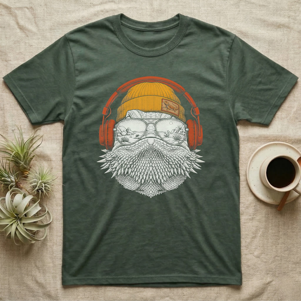Bearded Dragon Headphones T-Shirt in Military Green — Engraved bearded dragon with spiked beard in a beanie and headphones, aviators reflecting a desert canyon.