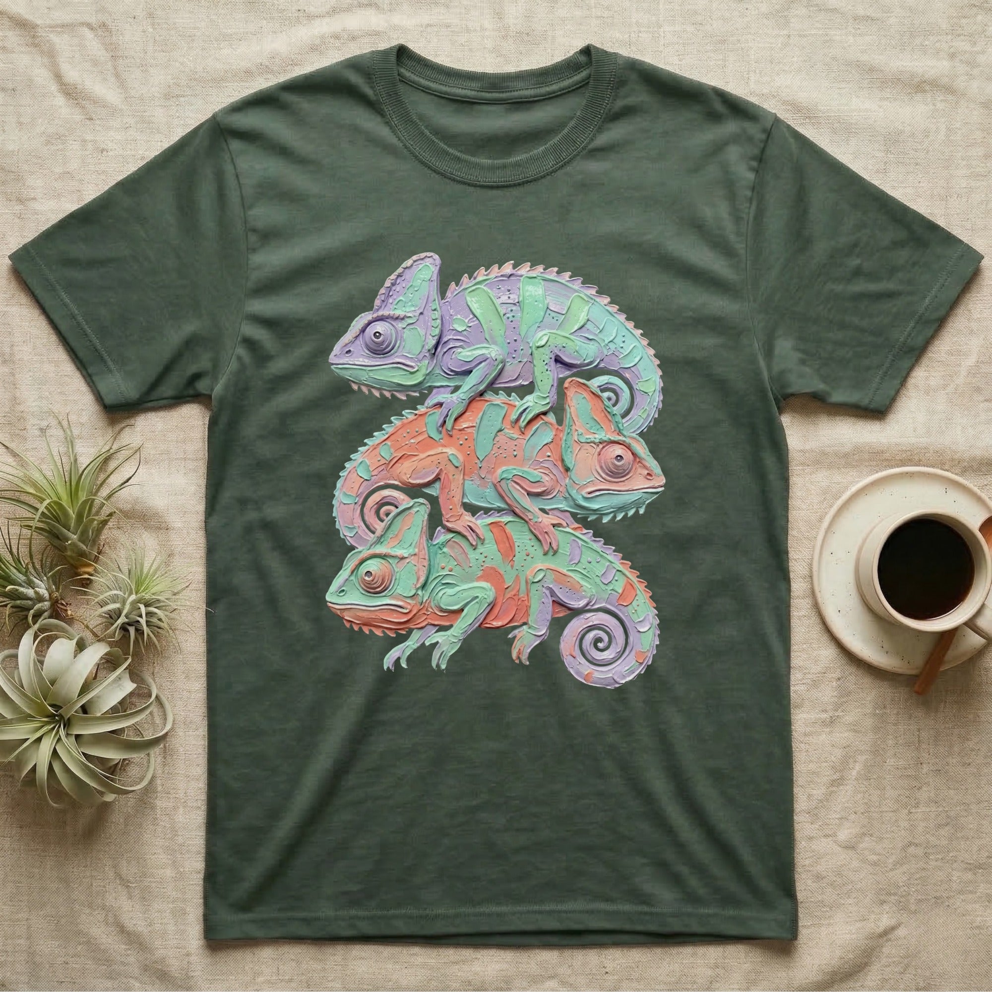 Green t-shirt with three stacked chameleons in purple, orange, and teal.