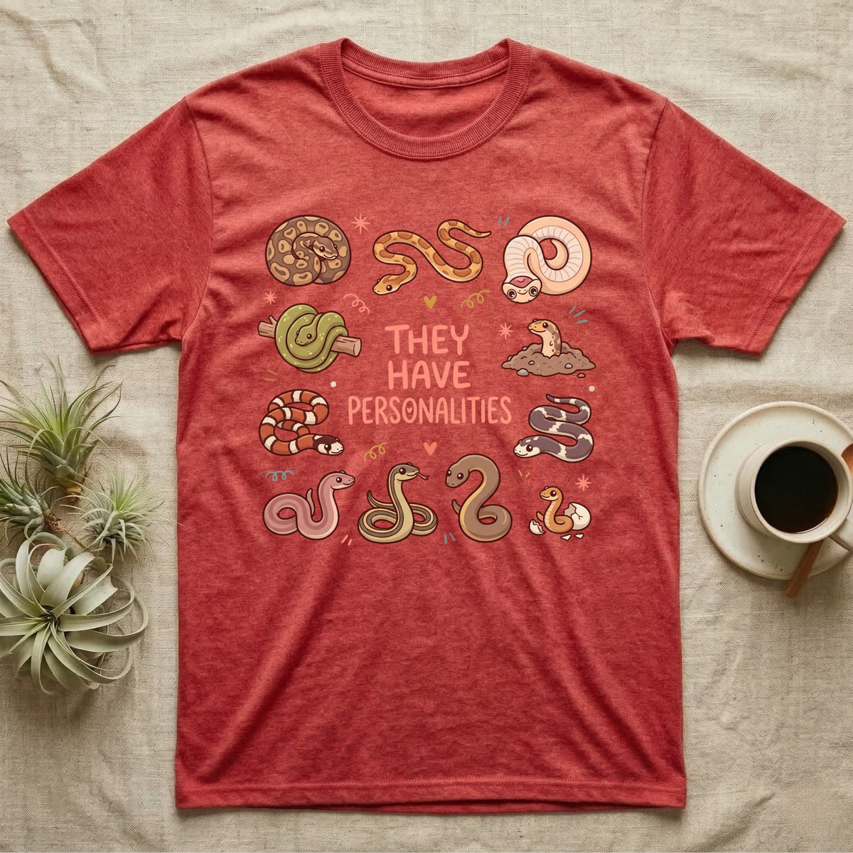 Snake Keeper Personalities T-Shirt in Heather Red — Outline illustration of five snakes in different postures scattered around hand-lettered script on grey.
