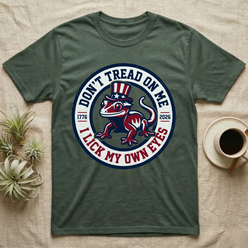 Crested Gecko 1776 T-Shirt in Military Green — Distressed crest of a crested gecko in a top hat with text Don't Tread On Me and I Lick My Own Eyes.