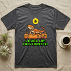Dark grey t-shirt with pixel art bearded dragon and "LEVEL UP: BUG HUNTER" text.