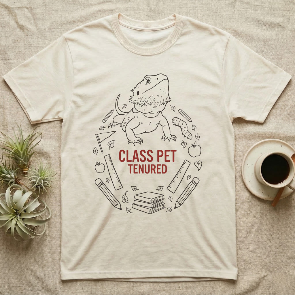 Bearded Dragon Class Pet T-Shirt in Natural — Bearded dragon in a heroic head-up pose ringed by outline school motifs with CLASS PET TENURED text on grey