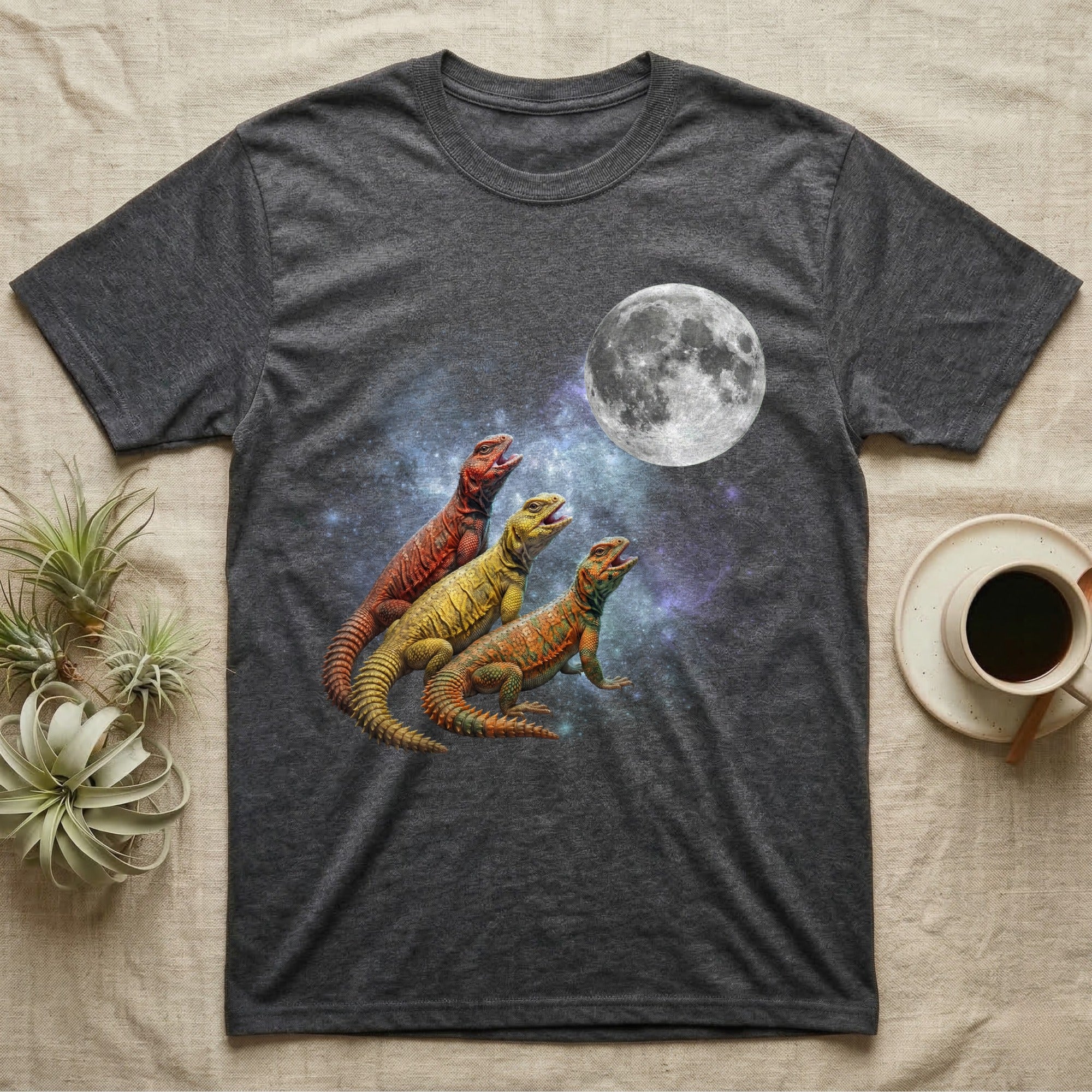 Uromastyx Moon Howl T-Shirt in Dark Heather — Three Uromastyx colour morphs howling at a full moon over a nebula on a dark grey t-shirt.