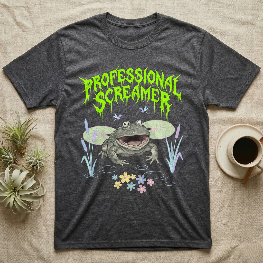 Budgett's Frog Feral T-Shirt in Dark Heather — Budgett's frog with wide screaming mouth under jagged acid-green metal text PROFESSIONAL SCREAMER with lily pads