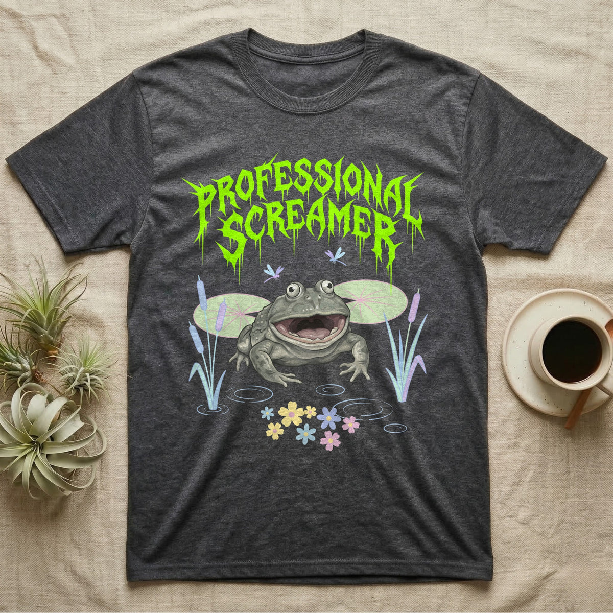 Budgett's Frog Feral T-Shirt in Dark Heather — Budgett's frog with wide screaming mouth under jagged acid-green metal text PROFESSIONAL SCREAMER with lily pads