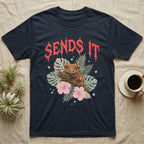 Crested Gecko Feral T-Shirt in Navy — Crested gecko on a mossy branch in a pastel jungle scene under a spiky coral metal wordmark reading SENDS IT.