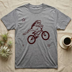 Tree Frog Can-Can T-Shirt in Sport Grey — Distressed one-ink oxblood screenprint of a White's tree frog airborne on a BMX bike, both back legs kicked off the pedals and swung to one side, hands still on the bars.