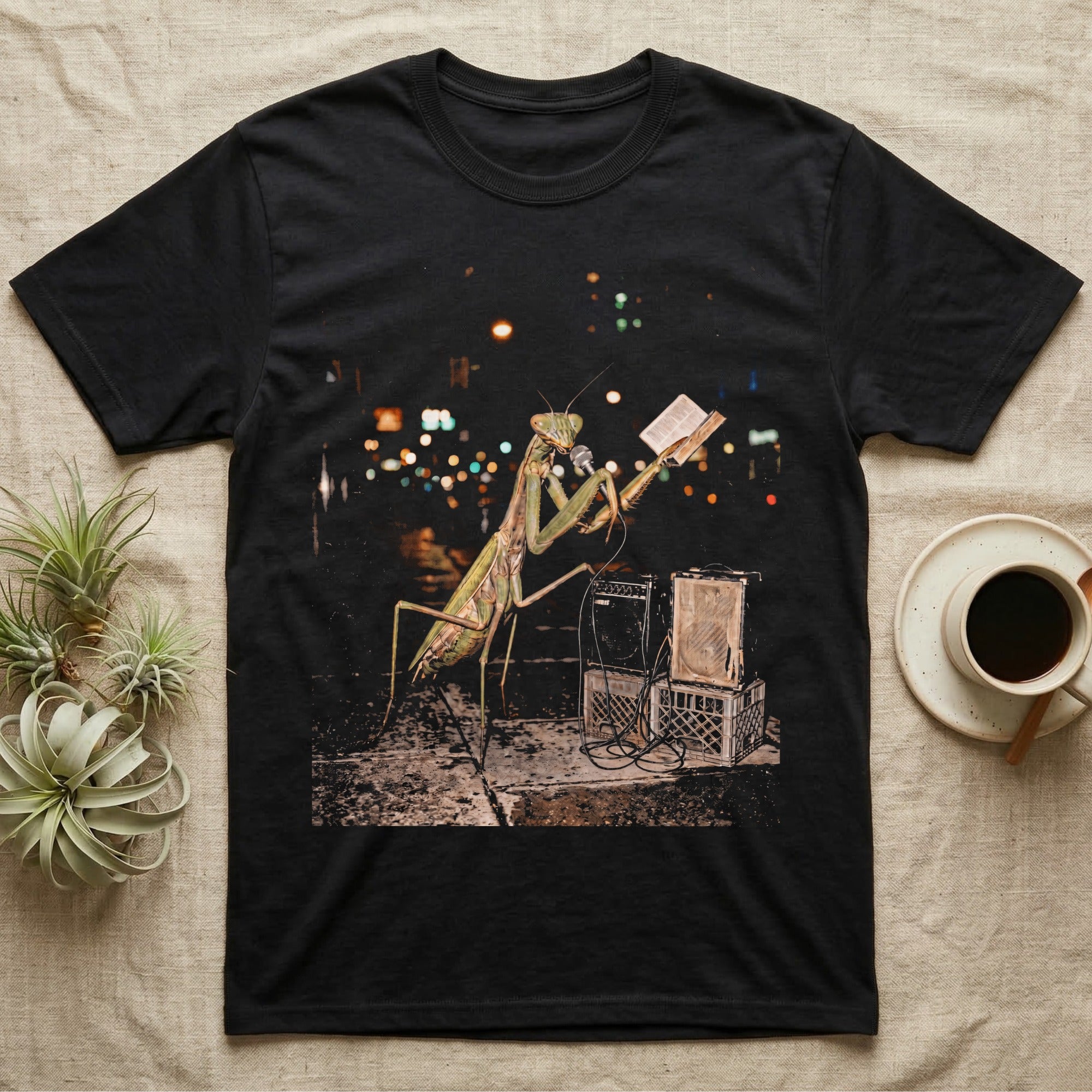 Praying Mantis Preacher T-Shirt in Black — Praying mantis as a night street preacher holding an open book and vintage microphone by milk-crate speakers in gritty halftone.
