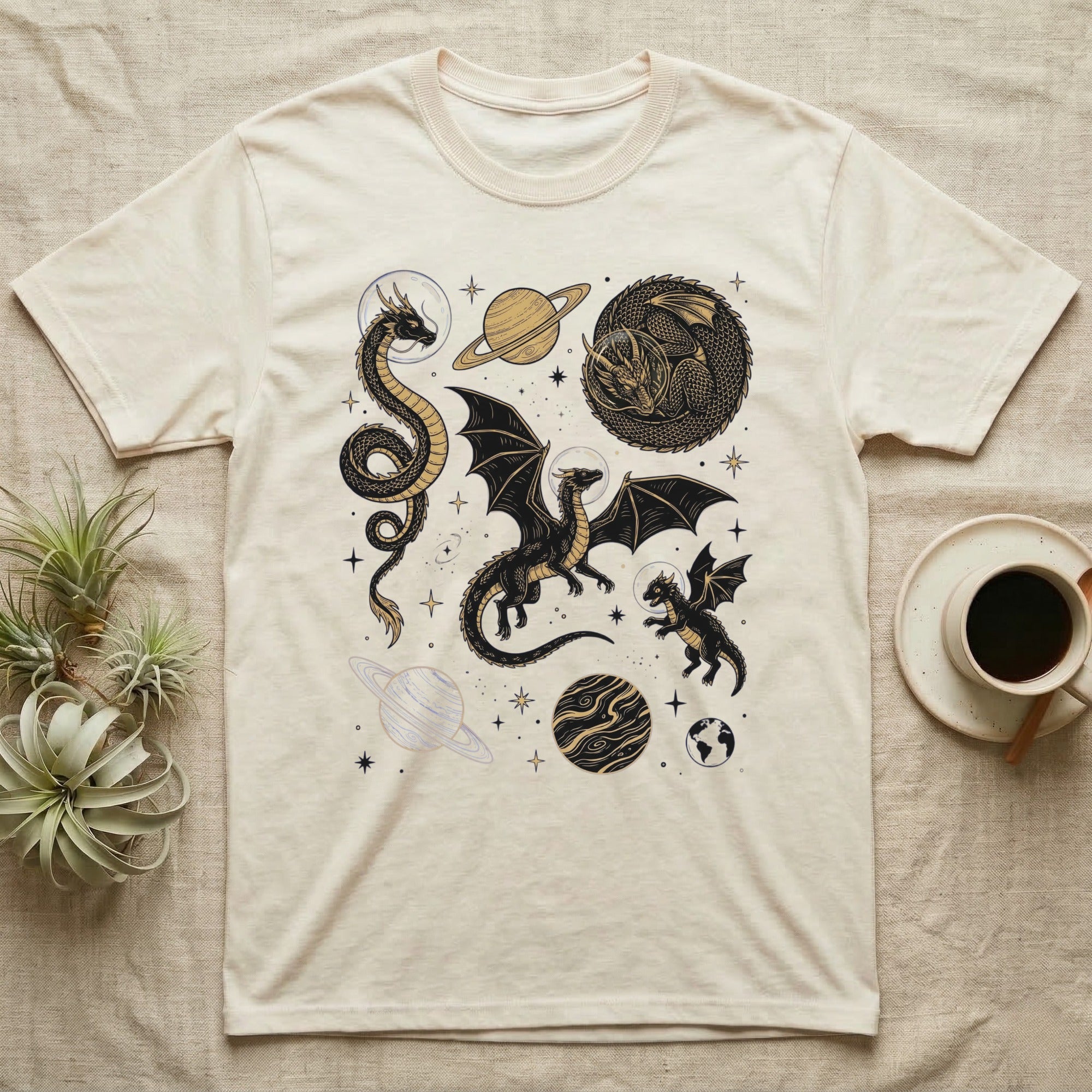 Cream t-shirt with black dragon and planet celestial graphic design.