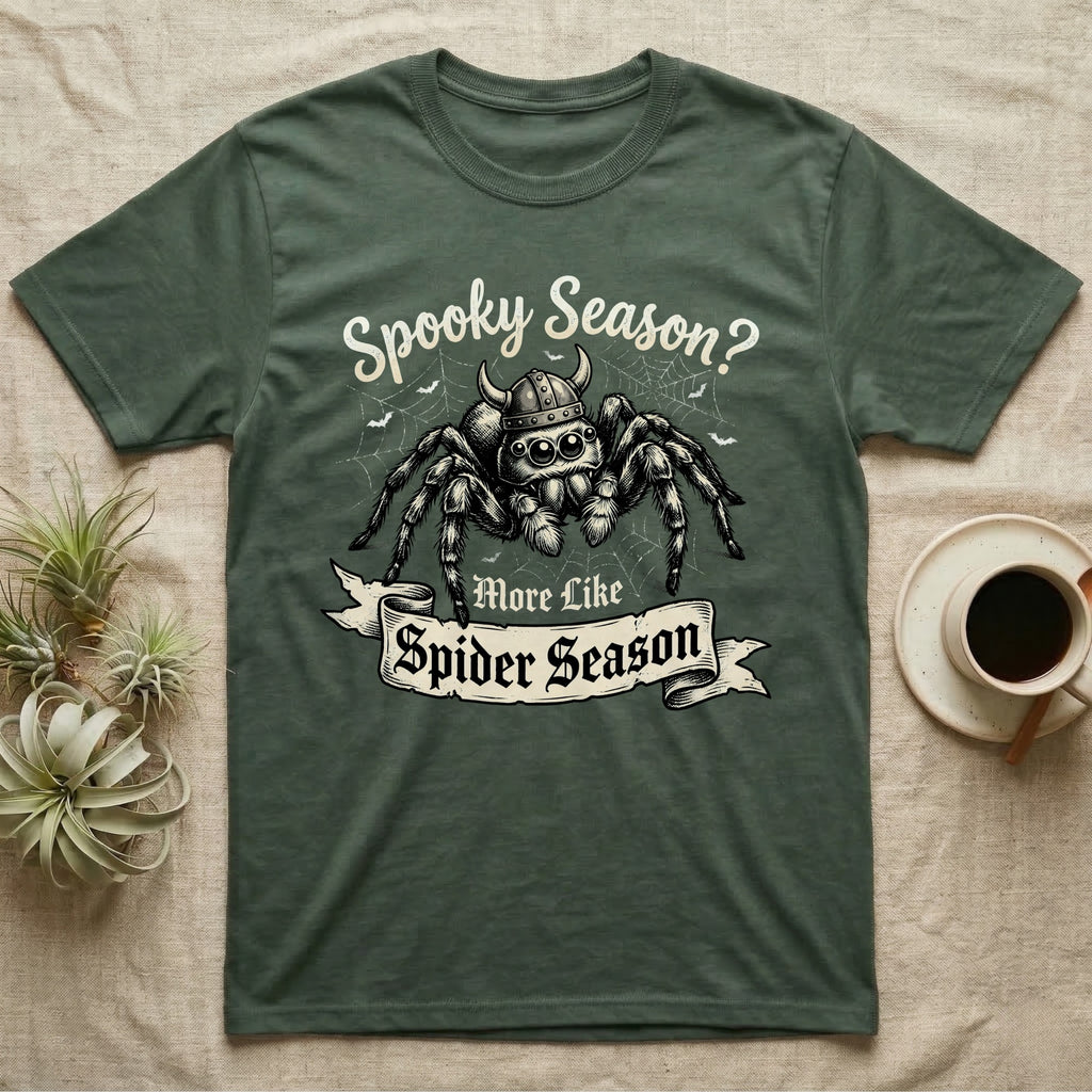 Jumping Spider Viking Helmet T-Shirt in Military Green — Ink-sketch jumping spider in a Viking helmet over a web, banner reading "More Like Spider Season."