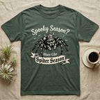Jumping Spider Viking Helmet T-Shirt in Military Green — Ink-sketch jumping spider in a Viking helmet over a web, banner reading "More Like Spider Season."