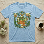 Light blue t-shirt with "The Bog Hoppers" and frogs playing instruments on a mushroom.
