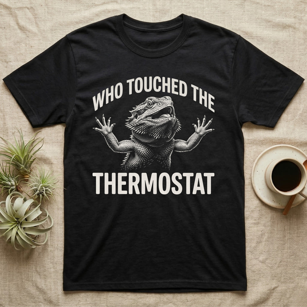 Bearded Dragon Thermostat T-Shirt in Black — White-line engraving of a bearded dragon flinging both arms up and yelling under the words Who Touched The Thermostat