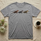 Crocodile Skink Morph Triptych T-Shirt in Sport Grey — Three red-eyed crocodile skinks in a row, painted in thick impasto — bronze, near-black and pale olive forms.