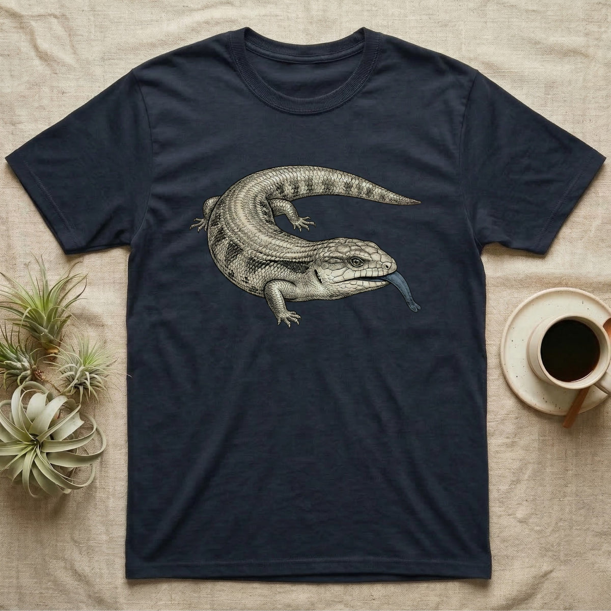 Navy t-shirt with a blue-tongued skink illustration licking its tongue.