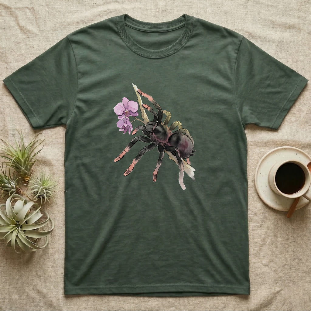 Pink-Toe Tarantula Blossom T-Shirt in Military Green — Watercolor illustration of a charcoal pink-toe tarantula with salmon toe tips holding an orchid blossom sprig, on a dark grey t-shirt.