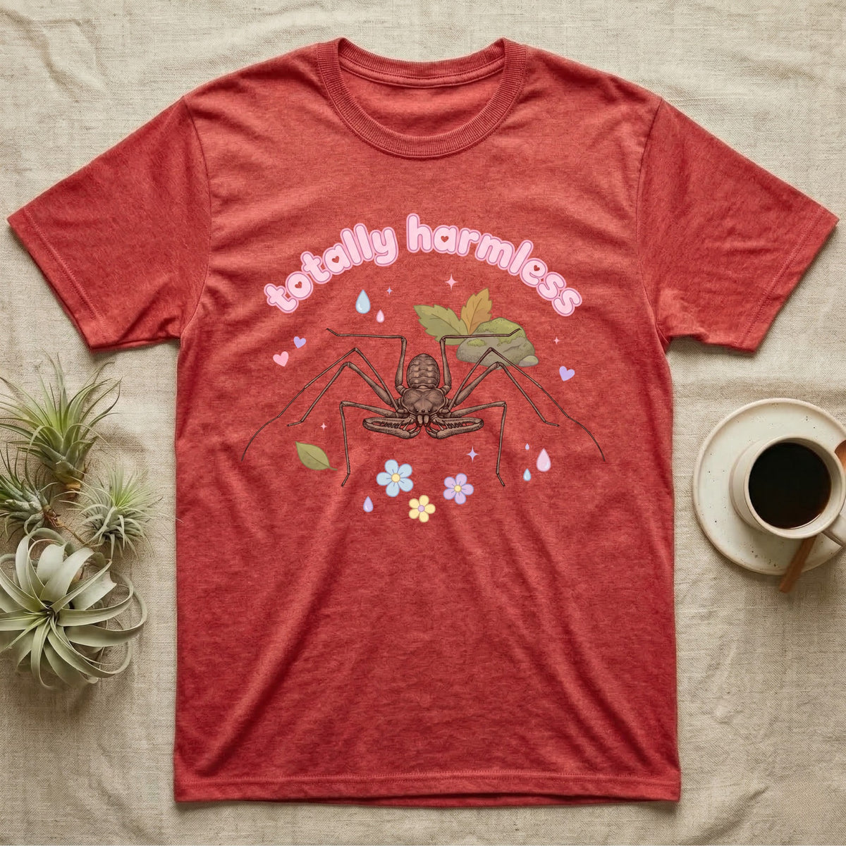 Tailless Whip Scorpion Baby T-Shirt in Heather Red — Pastel tailless whip scorpion with long whip legs among leaves and blossoms, puffy pink wordmark "totally harmless" above.