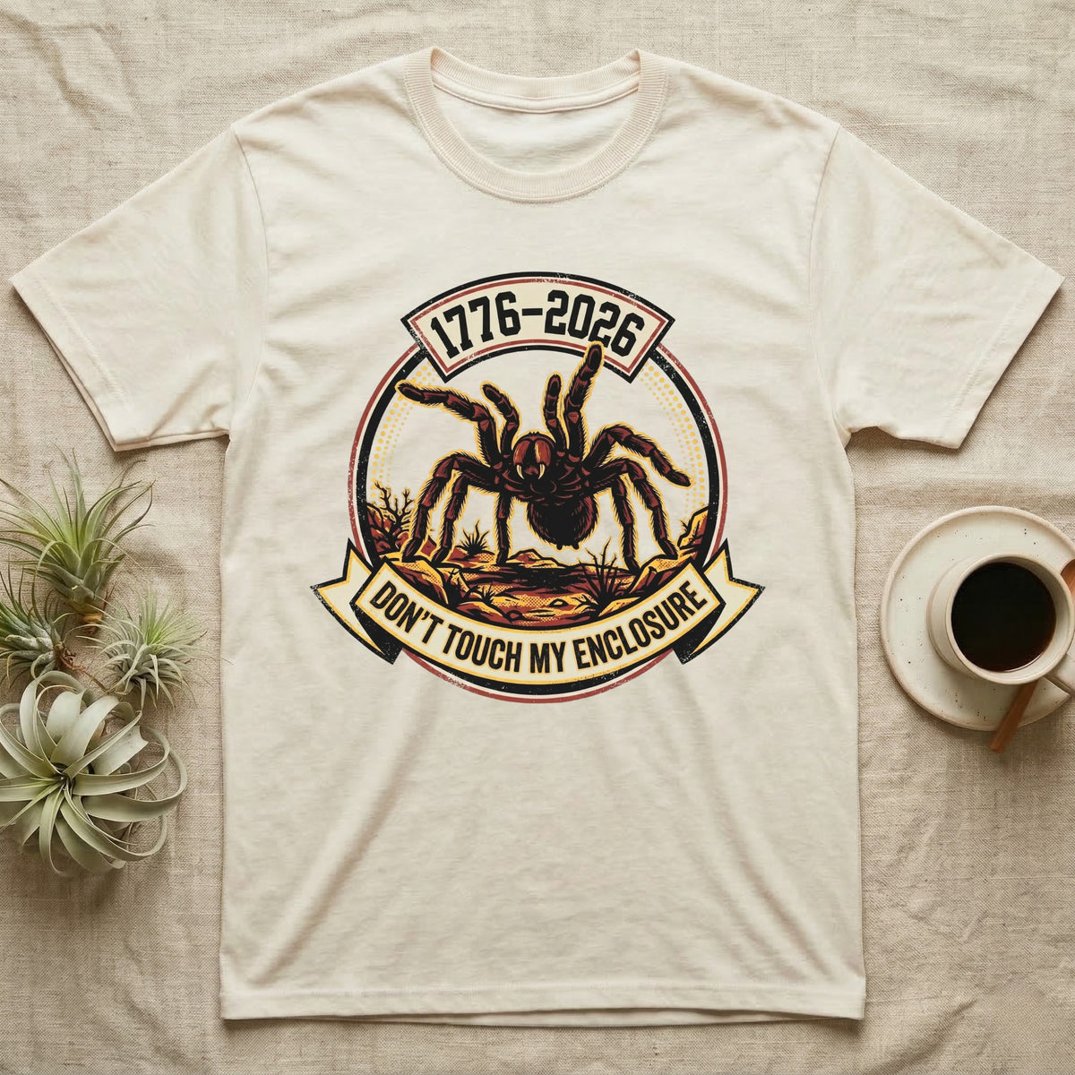 Tarantula Don't Touch Enclosure Tee in Natural — Distressed circular badge of a defensive tarantula on desert ground, red and gold banner reading Don't Touch My Enclosure, on black.