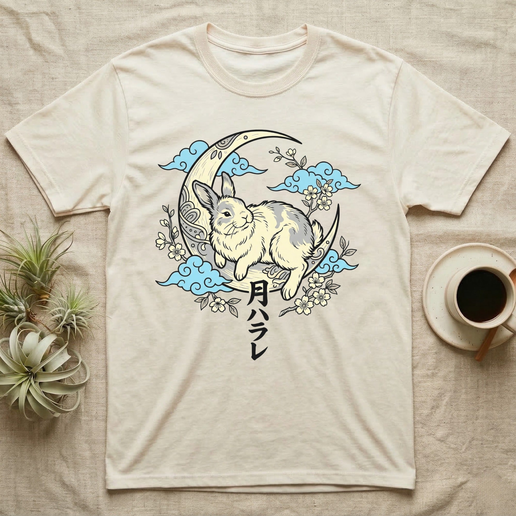 Cream t-shirt with rabbit on moon and Japanese text.