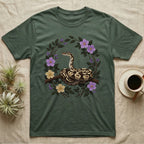 Ball Python Opinions Television T-Shirt in Military Green — Oil-painted ball python coiled on a branch, enclosed by a dense oval bower of flowering bramble.