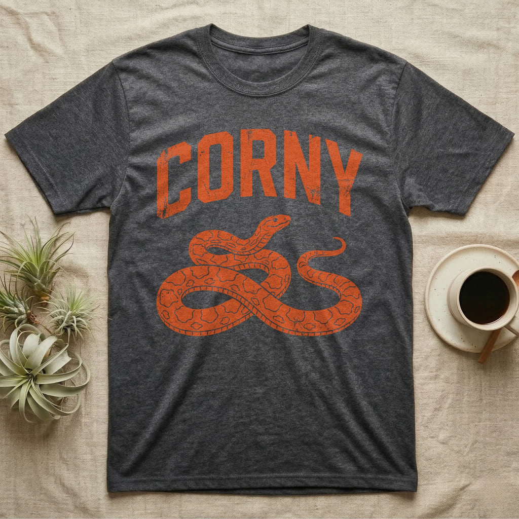 Corn Snake Corny T-Shirt in Dark Heather — Worn orange one-ink print of a corn snake lying in loose coils, head raised, under the arched word Corny