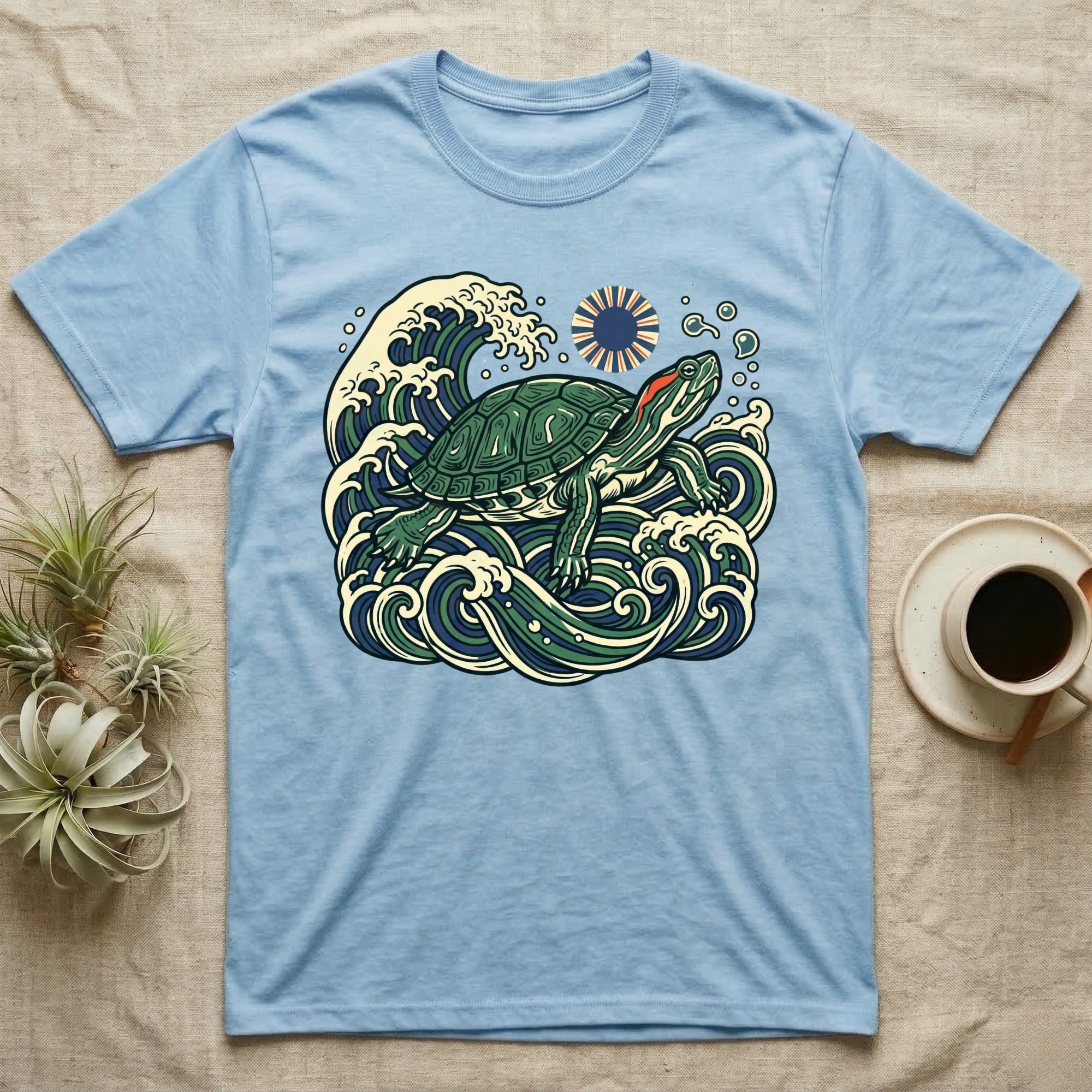 Blue t-shirt with a stylized turtle and wave design.