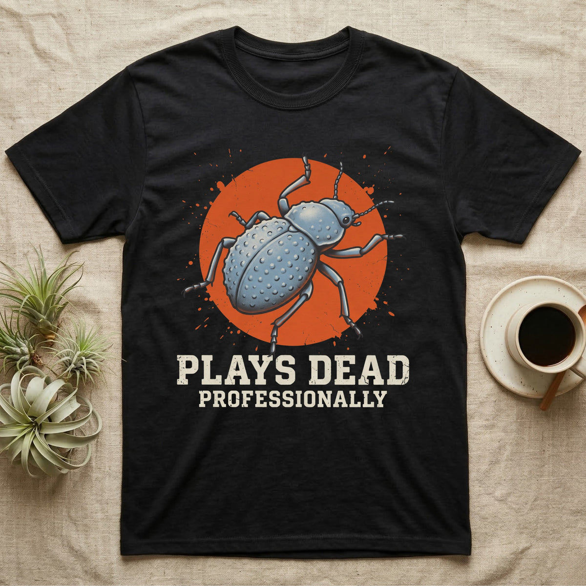 Blue Death Feigning Beetle T-Shirt in Black — Distressed disc portrait of a blue death-feigning beetle over an orange circle with text plays dead