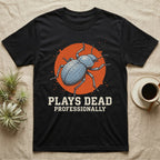 Blue Death Feigning Beetle T-Shirt in Black — Distressed disc portrait of a blue death-feigning beetle over an orange circle with text plays dead