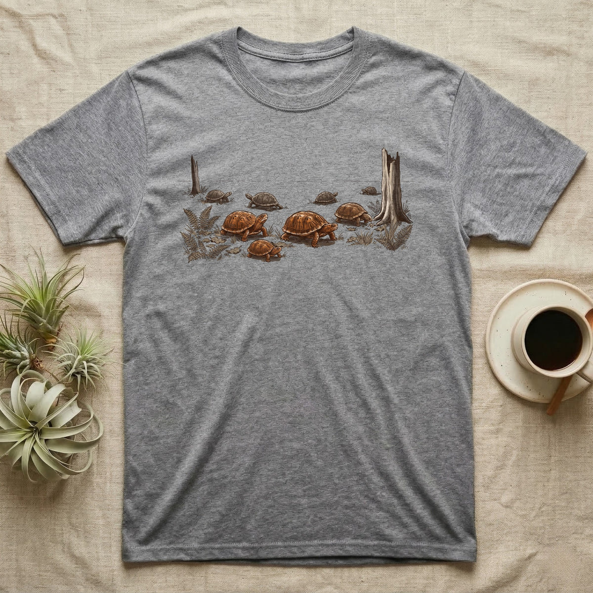 Box Turtle Forest Floor T-Shirt in Sport Grey — Sepia ink and wash illustration of eight eastern box turtles crossing open woodland between two deadfall trunks.