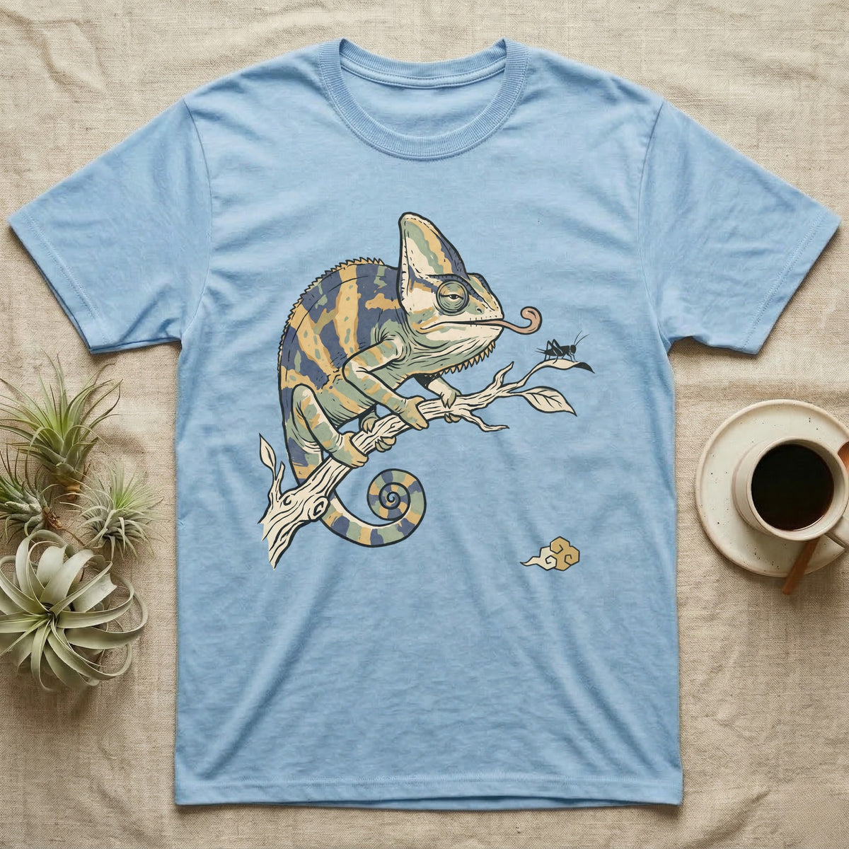 Veiled Chameleon Diet T-Shirt in Light Blue — Ukiyo-e woodblock illustration of a veiled chameleon extending its tongue, with a deadpan serif caption beneath the subject.