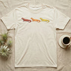 Uromastyx Colour Morph Trio T-Shirt in Natural — Three uromastyx lizards in a row, painted in thick raised relief — brick red, tangerine orange and lemon yellow morphs.