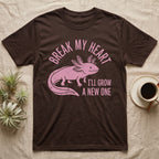 Axolotl Regrow T-Shirt in Dark Chocolate — Worn one-ink pink axolotl walking side-on, gills spread, under Break My Heart, I'll Grow a New One
