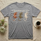 Crested Gecko Morph Chart T-Shirt in Sport Grey — Impasto painted chart of three crested gecko morphs — harlequin, pinstripe and dalmatian — labelled beneath each gecko.