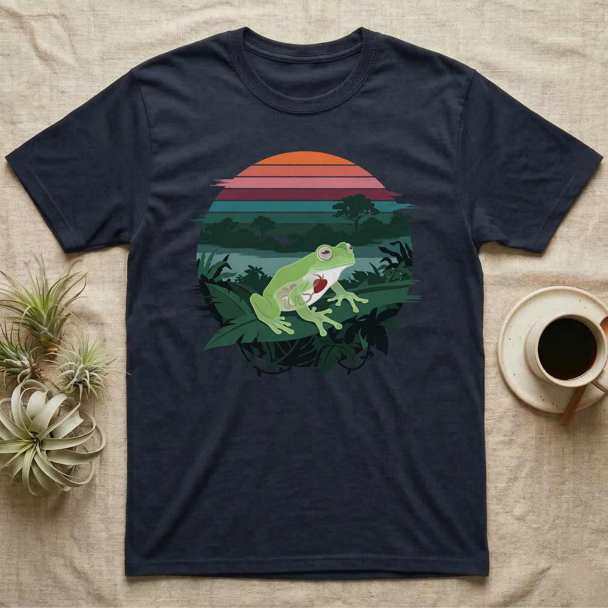 Glass Frog See-Through T-Shirt in Navy — Flat-colour circle-window illustration of a glass frog silhouetted crossing a rainforest canopy scene.