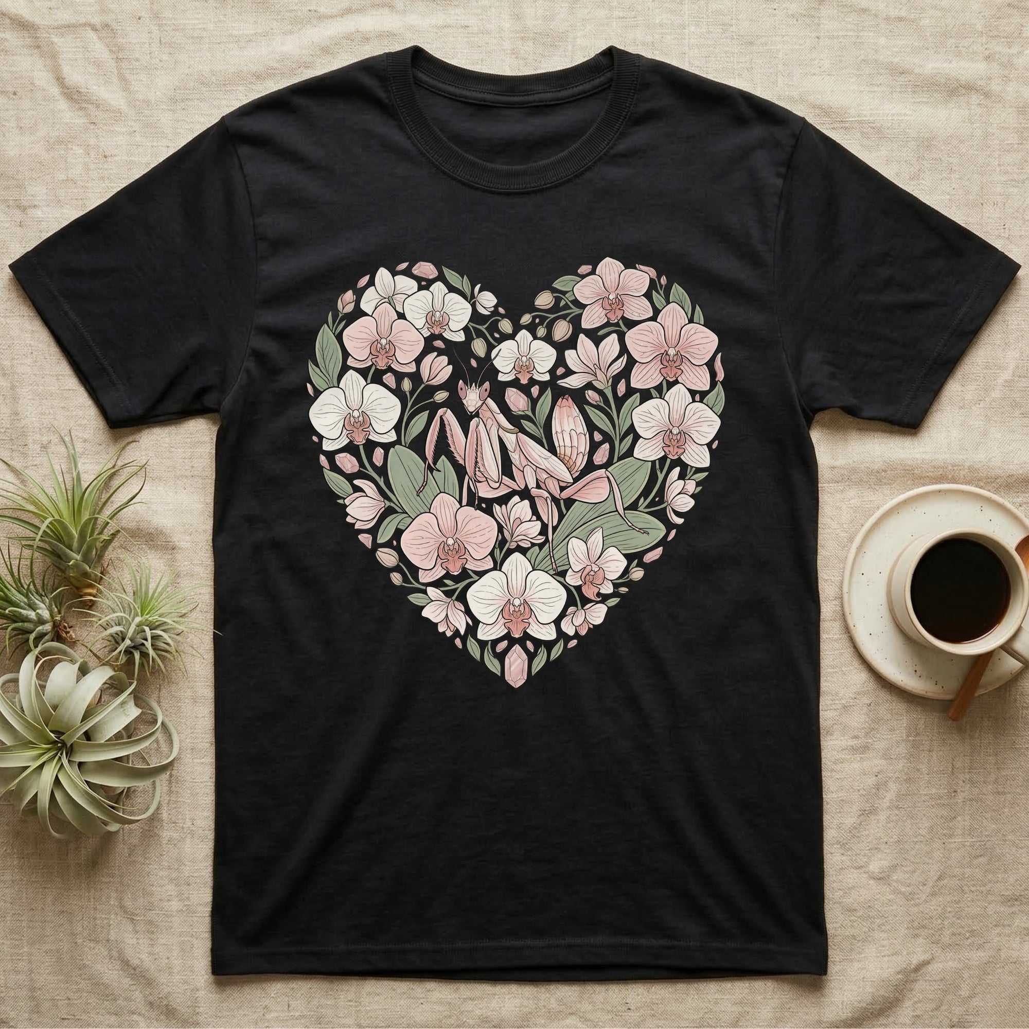 Black t-shirt with a heart-shaped floral design featuring orchids and a praying mantis.