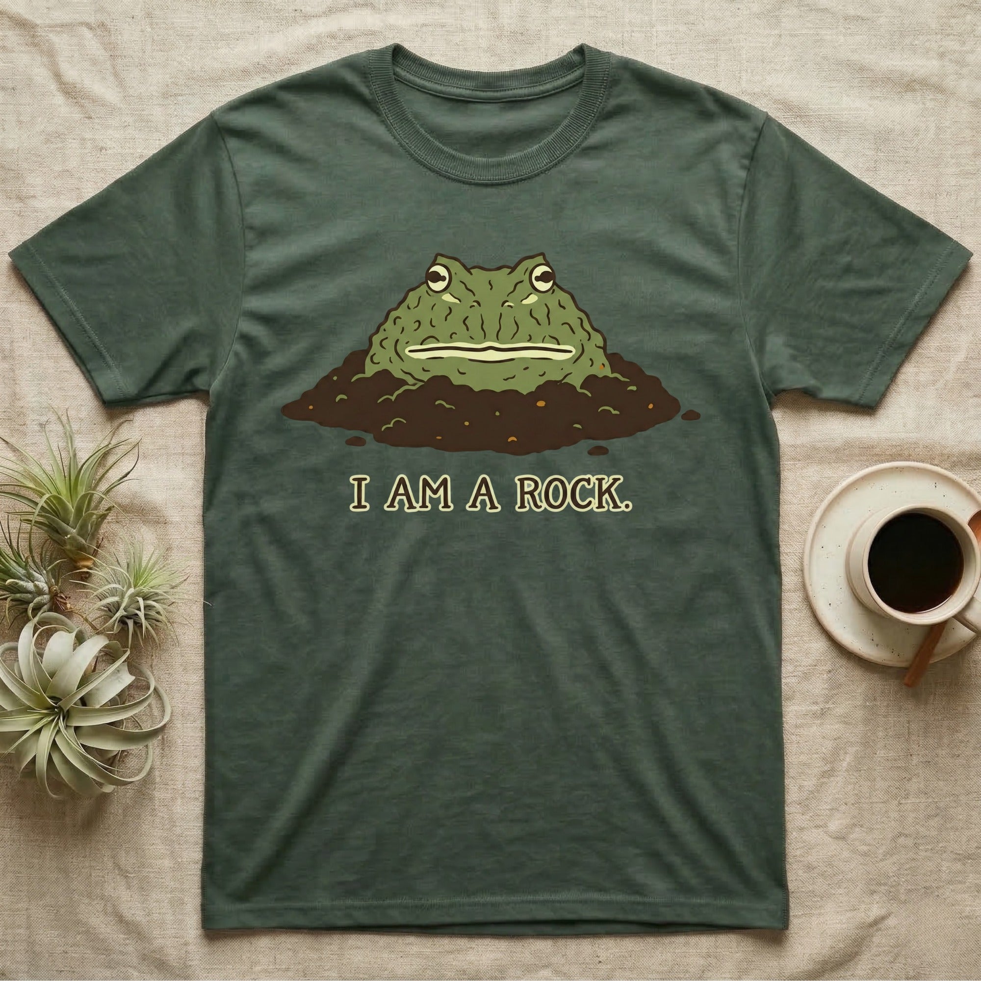 Green t-shirt with a cartoon frog emerging from the dirt, saying "I AM A ROCK."