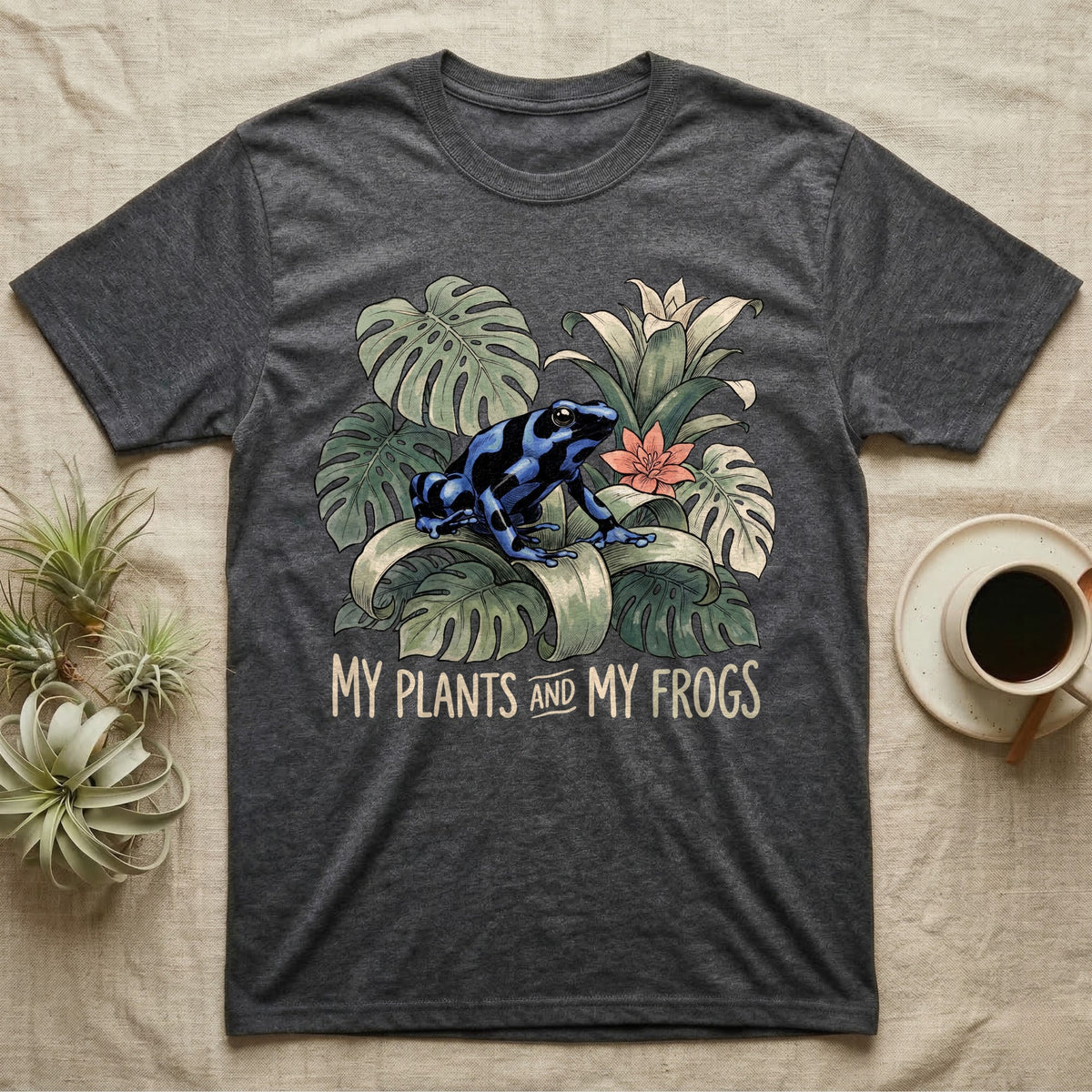 Plants And Frogs T-Shirt in Dark Heather — Naturalist-plate illustration of a dart frog perched in lush foliage with hand-lettered text reading My Plants And My Frogs.