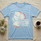 Betta Fights His Reflection T-Shirt in Light Blue — Grunge-distressed betta in full flare display with red fin accents and type "He Fights His Own Reflection Every Morning."