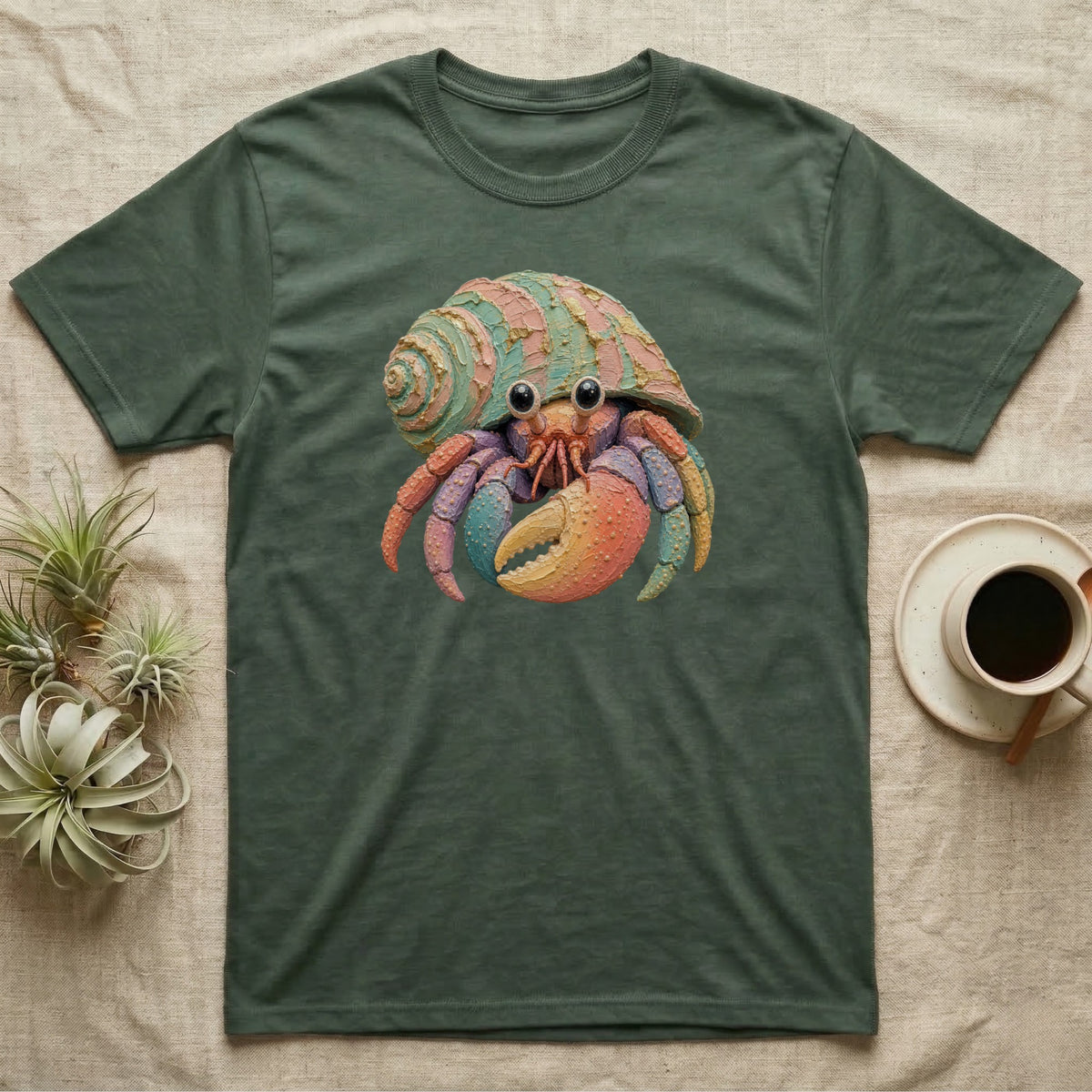 T-shirt featuring a colorful cartoon hermit crab with a shell.