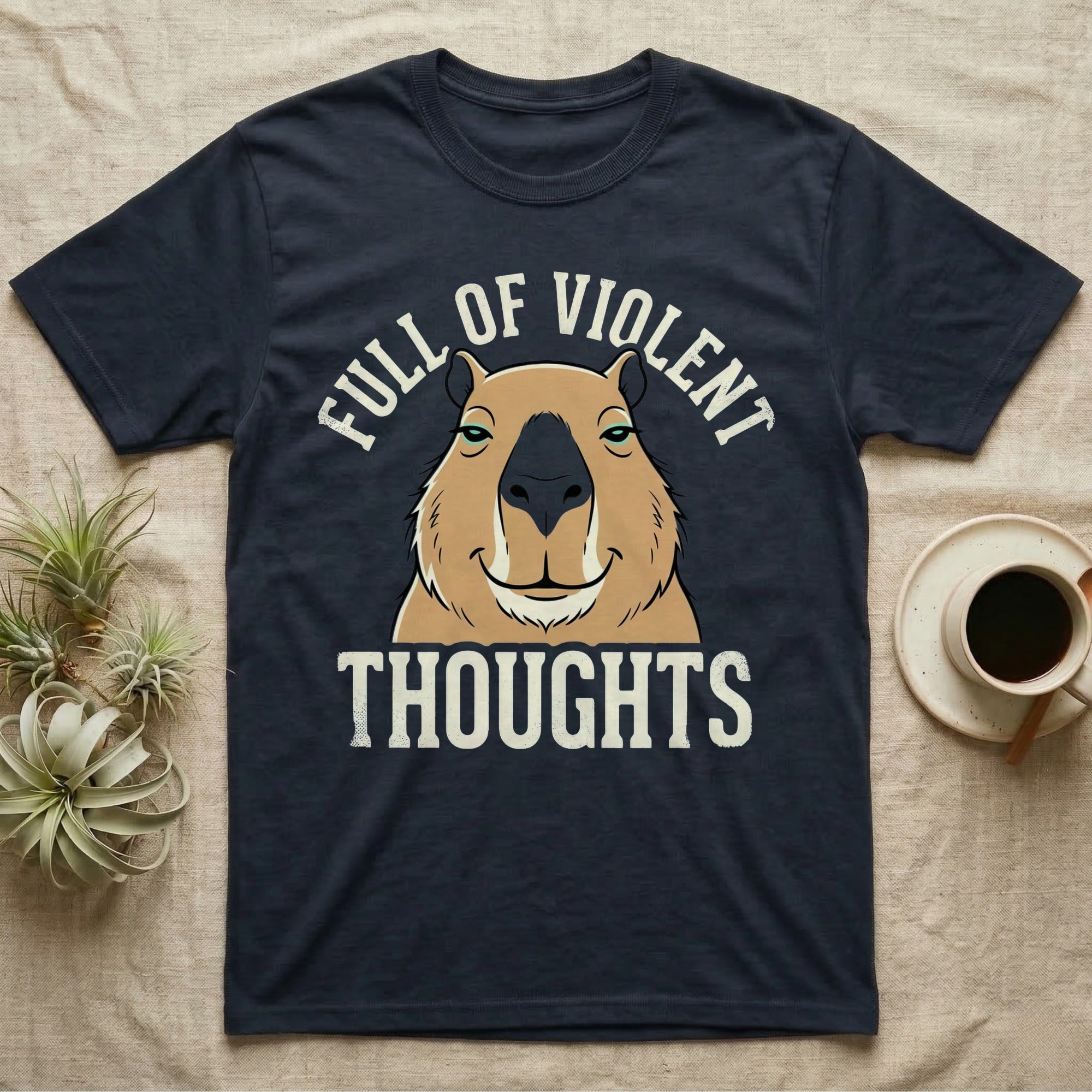 Capybara Violent Thoughts Tee in Navy — Vector-bold portrait of a serenely half-smiling capybara framed by cream slab typography reading "Full Of Violent Thoughts."