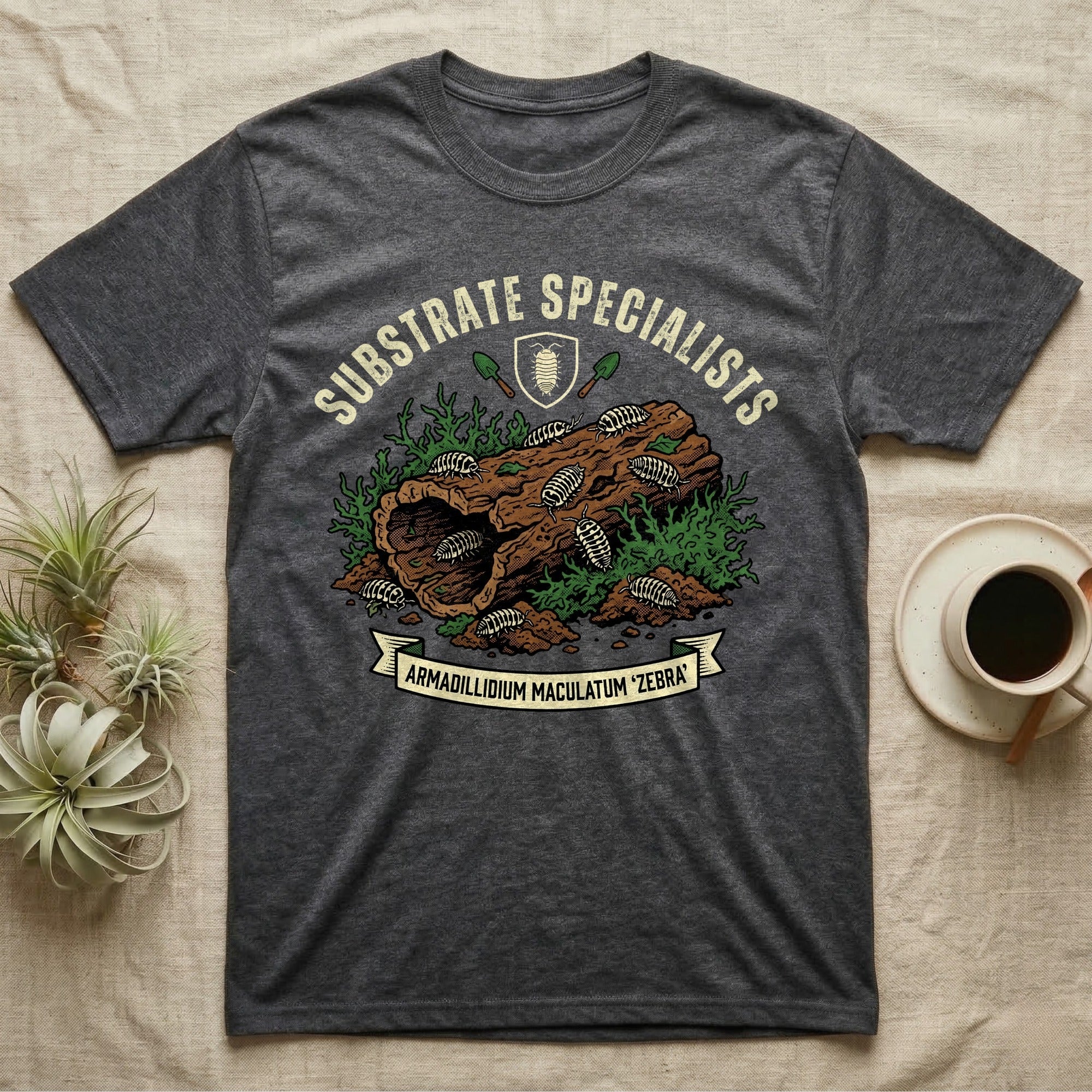 Zebra Isopod Substrate Specialists T-Shirt in Dark Heather — Vintage crest of zebra isopods on a mossy cork log with crossed trowels and Armadillidium ribbon.