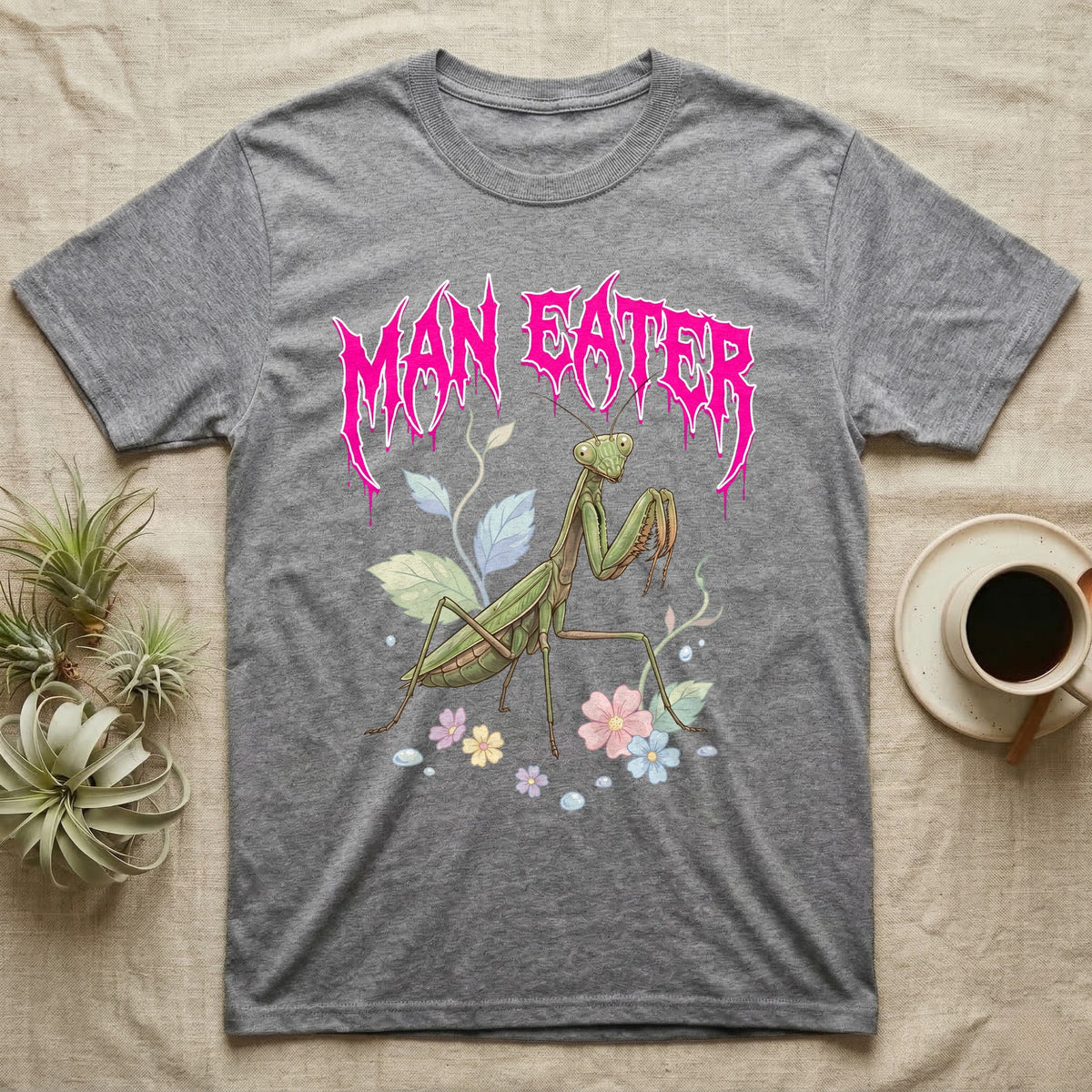Chinese Mantis Feral T-Shirt in Sport Grey — Pastel Chinese mantis with raised spiked forelegs among leaves and blossoms, jagged magenta metal wordmark "MAN EATER" above.