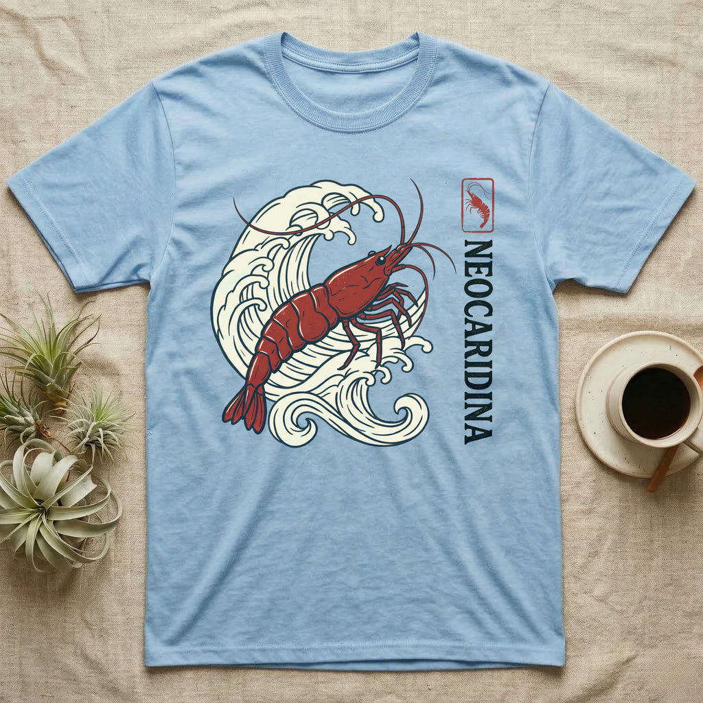 Light blue t-shirt with red shrimp and waves graphic.