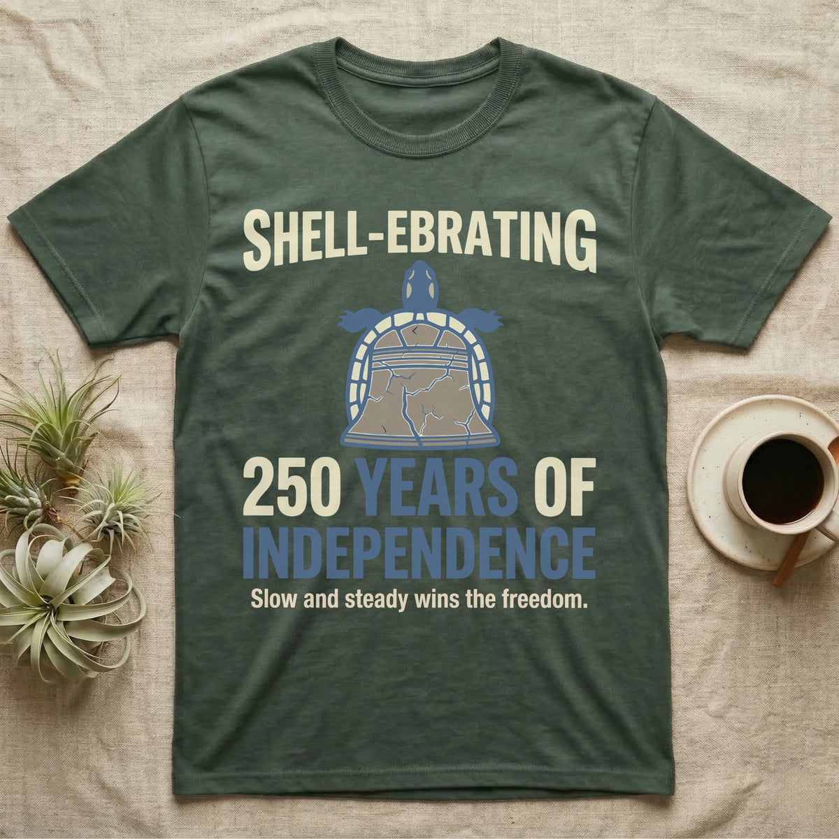 Sea Turtle Liberty Bell T-Shirt in Military Green — Slate-blue and cream tee of a sea turtle whose shell is drawn as the Liberty Bell under Shell-Ebrating 250 Years text.