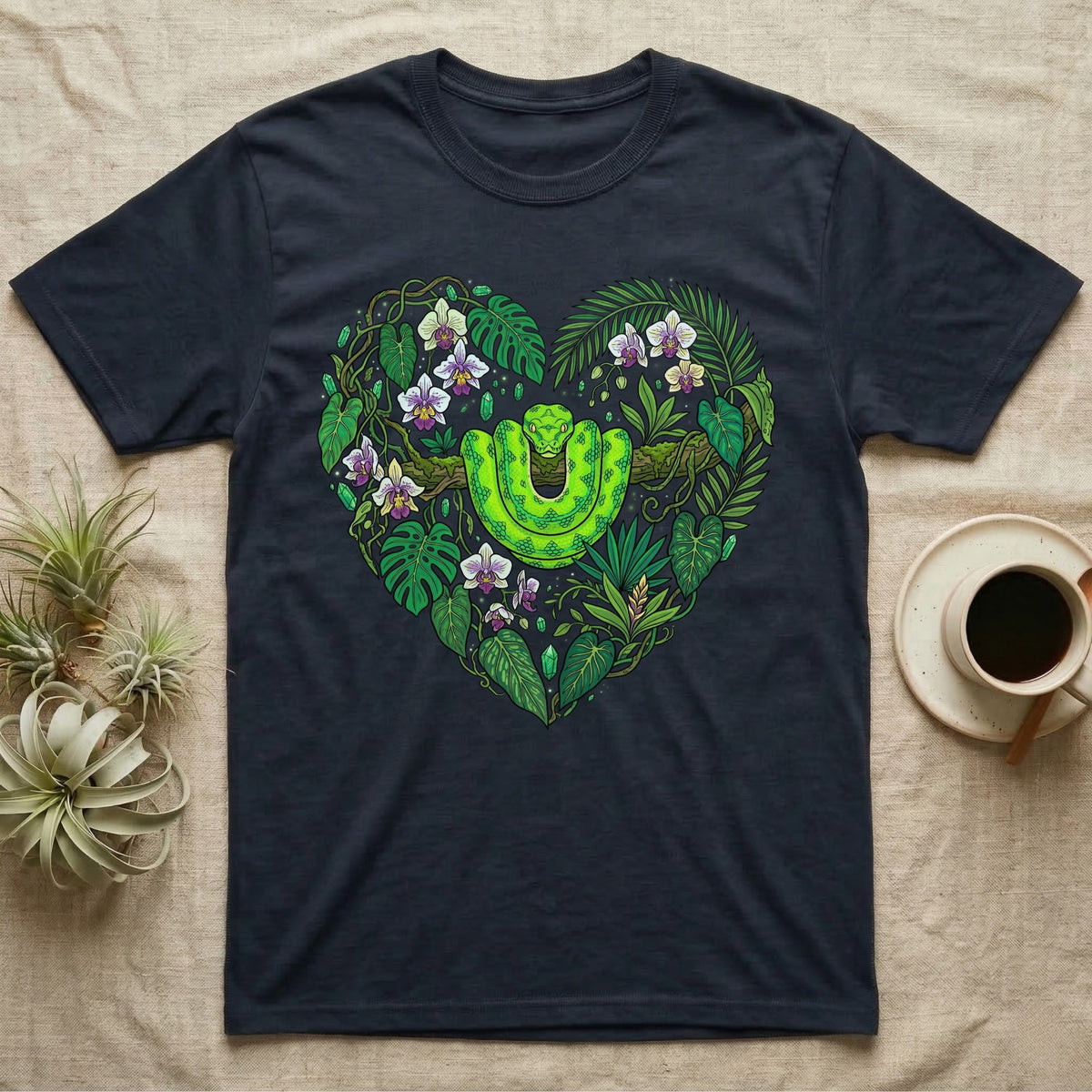 Dark t-shirt with a heart-shaped jungle design featuring a green snake.