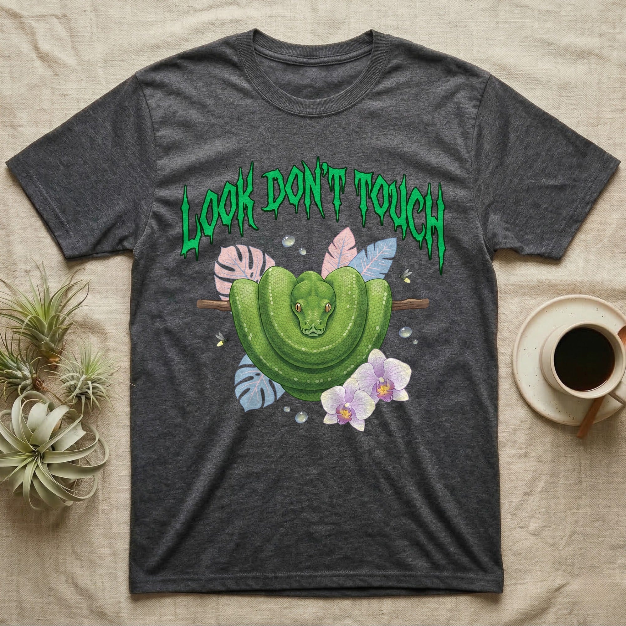 Green Tree Python Feral T-Shirt in Dark Heather — Green tree python in a saddle coil on a branch under a jagged emerald metal "LOOK DON'T TOUCH" wordmark and orchids.