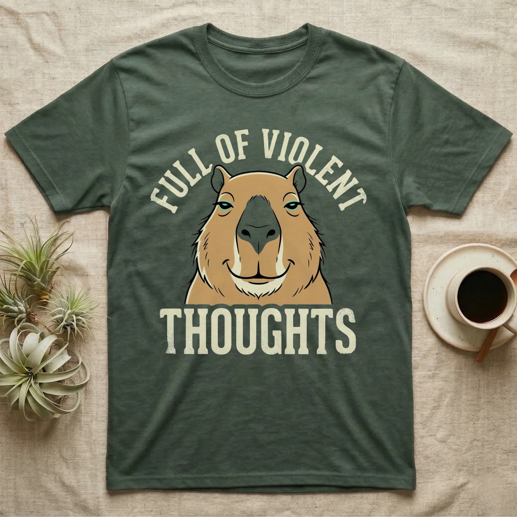 Capybara Violent Thoughts Tee in Military Green — Vector-bold portrait of a serenely half-smiling capybara framed by cream slab typography reading "Full Of Violent Thoughts."
