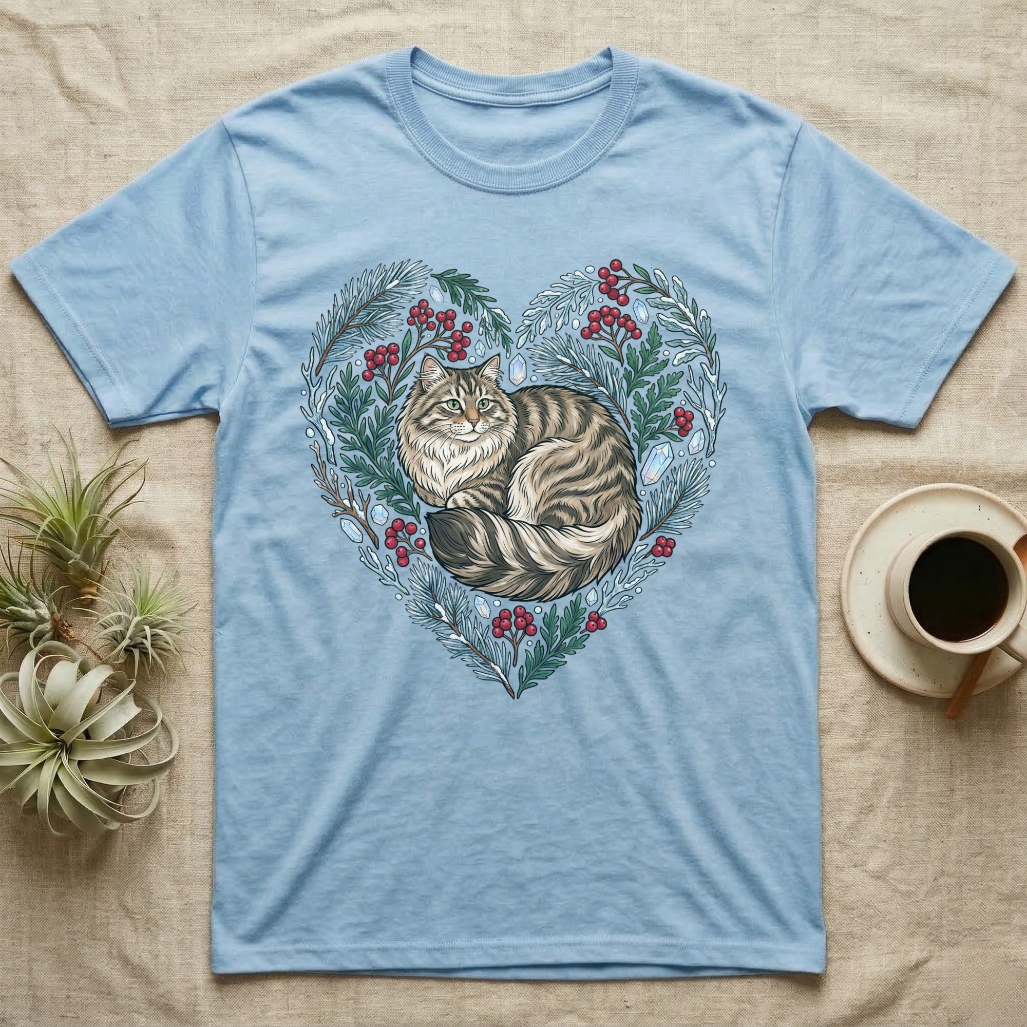 Light blue t-shirt with a cat illustration in a heart-shaped floral wreath.
