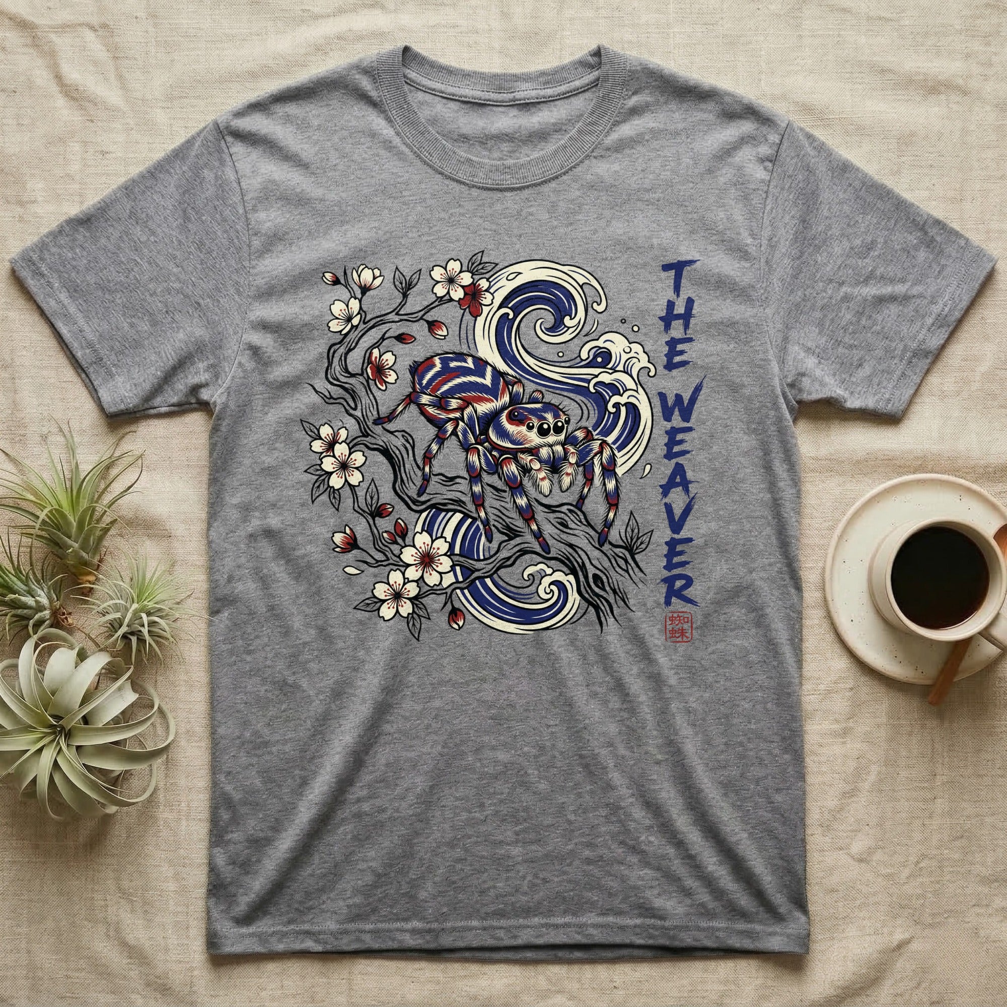 Grey t-shirt with spider, cherry blossoms, and waves graphic.